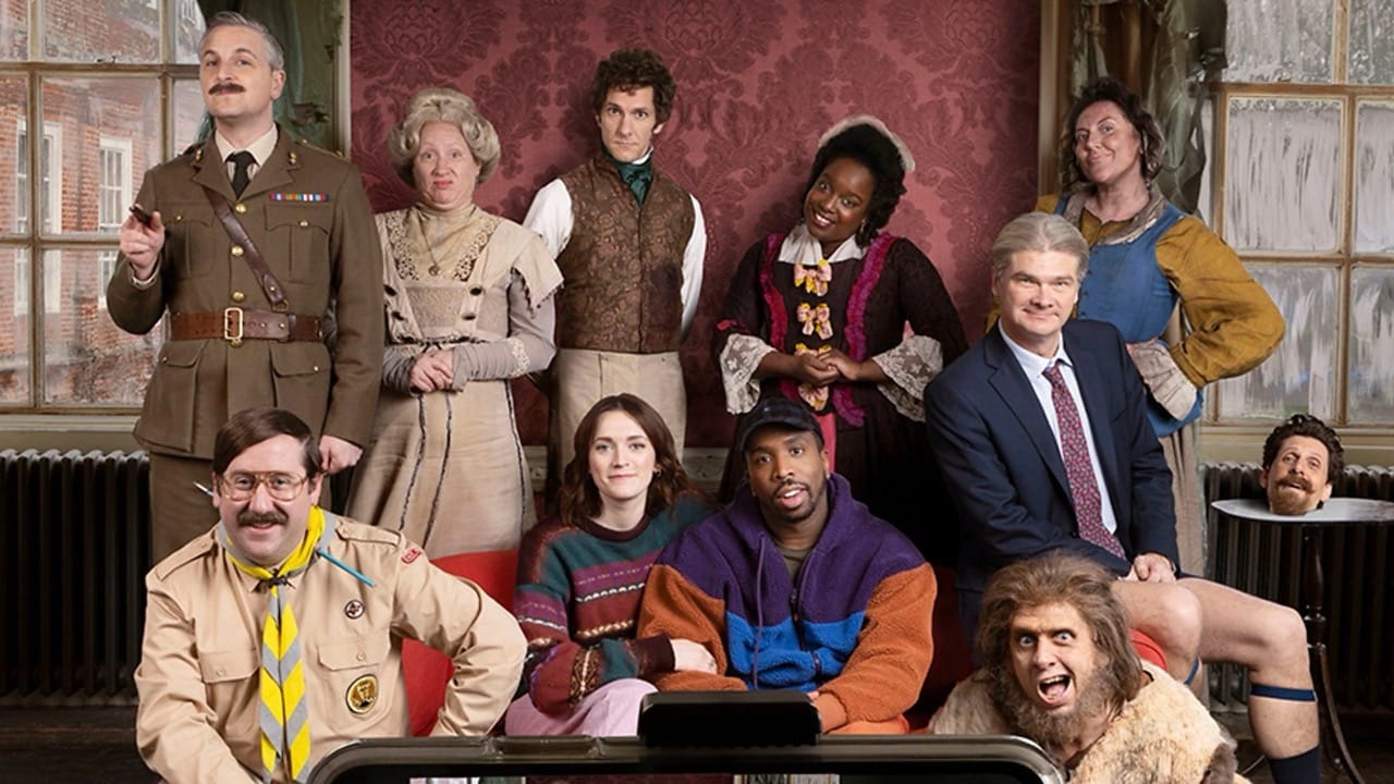 A man and woman are seated on a small couch, surrounded by odd characters clearly from different eras in history.