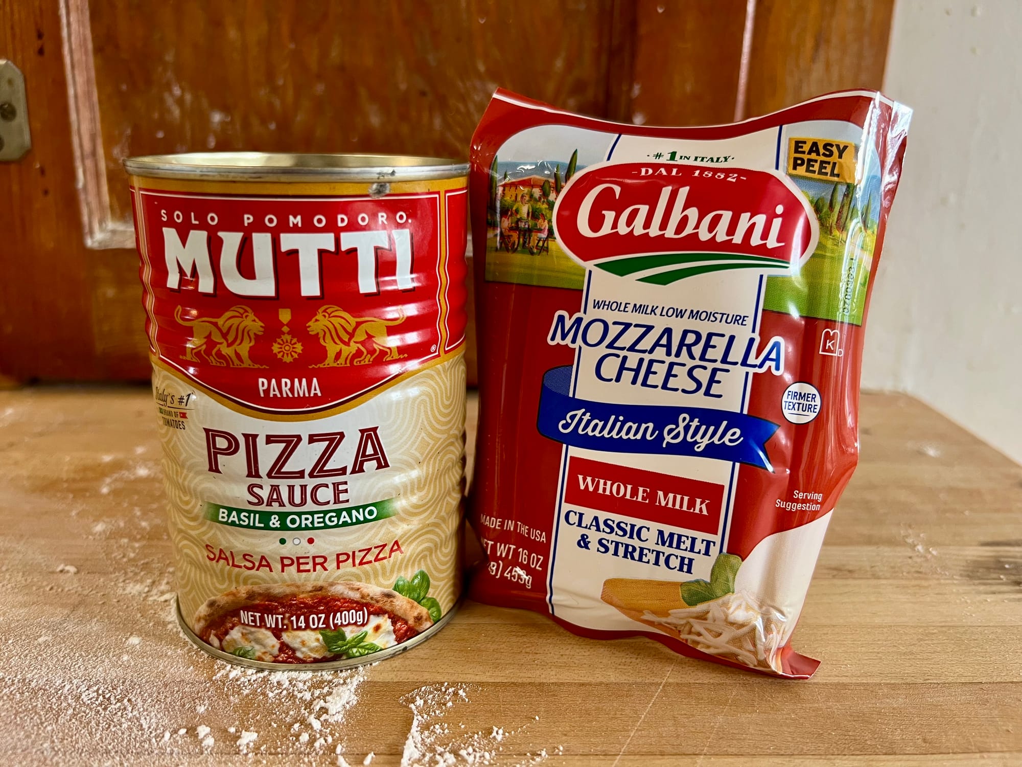 A can of Mutti pizza sauce and a package of Galbani mozzarella.