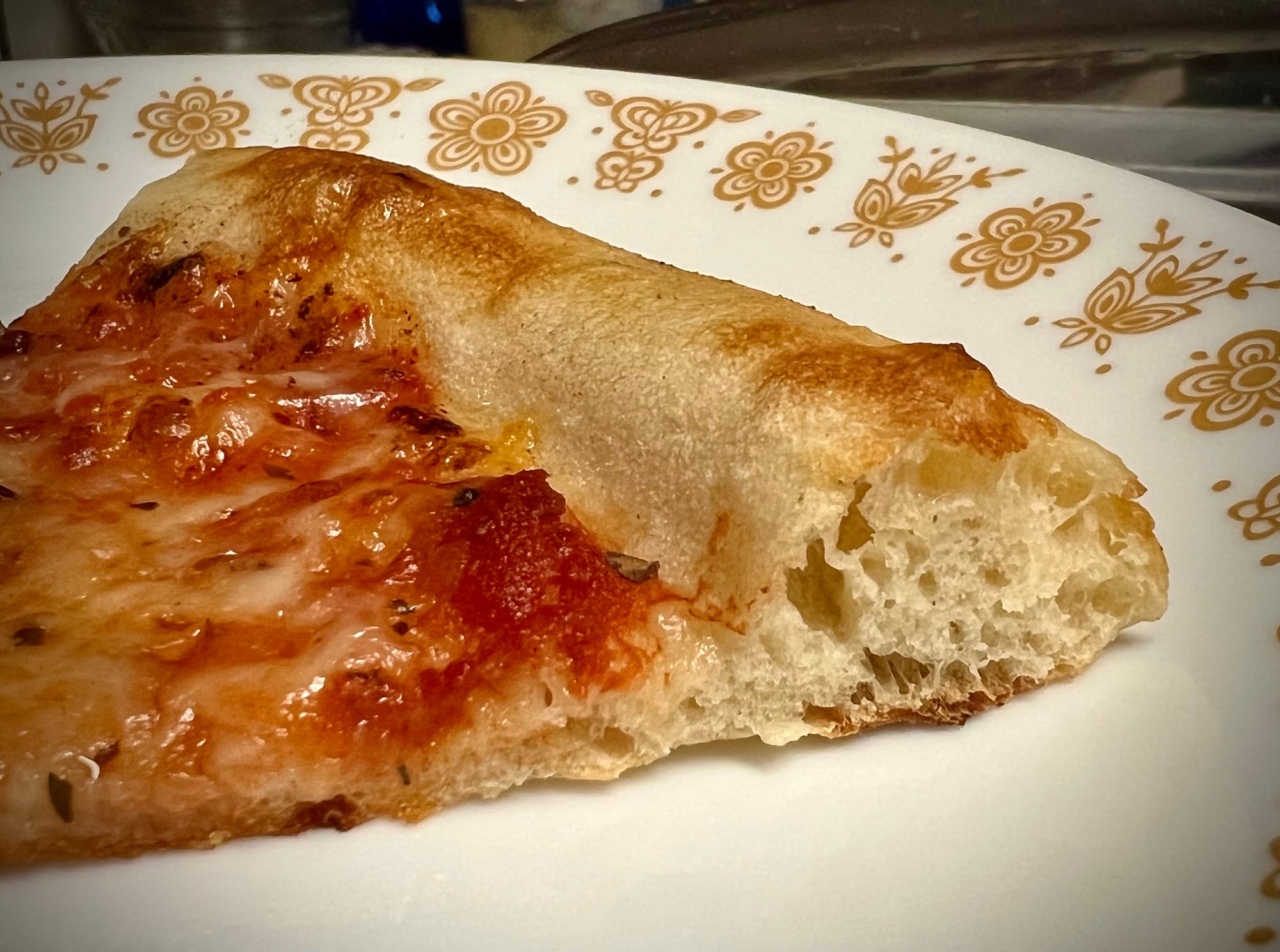 A close-up shot of the crust on a slice of pizza.