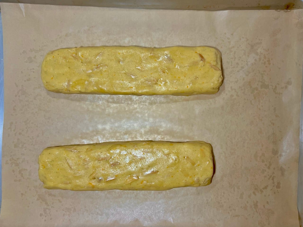 The two logs of biscotti dough have now been shaped into flattened, even bars.